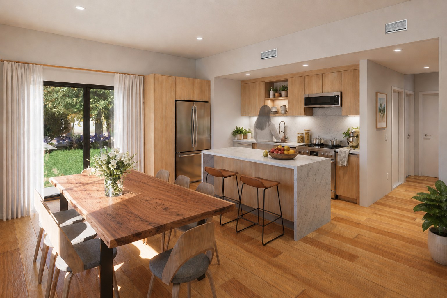 A bright, modern kitchen and dining area with wood floors, a marble island, and a view of a garden through sliding doors